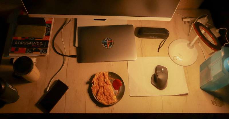 A vibrant spread of popular gaming snacks like energy bars, chips, and drinks arranged beside a gaming setup with RGB lighting